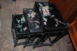 A nest of three black lacquered chinoiserie occasional Tables having decorated with flowering