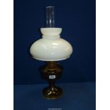 A brass Oil lamp with white glass shade.