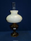 A brass Oil lamp with white glass shade.