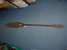 A carved wooden tribal fishing spear with broken tip 67" long.