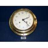 A brass Ship's clock, 9'' diameter.