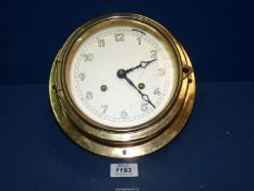 A brass Ship's clock, 9'' diameter.