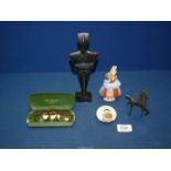 A black cast metal figure and a small figure horse, a small figure of a lady,