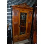 A Satinwood single Wardrobe having carved details,