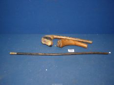 A Cheltenham college swagger stick and two carved walking handle parts,