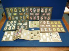 A small box of various cigarette card albums including Wills cigarettes, etc.