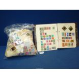 A World stamp album containing mixed stamps, plus loose stamps in bag.