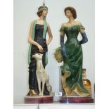 Two Art Nouveau style figures of ladies, one with a dog, some damage, 25" tall.