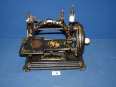 A 'Todd's Champion' manual Sewing machine having floral, gilded decoration.