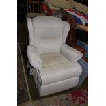 A pale beige lattice pattern fabric upholstered electrically reclining Armchair.