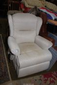 A pale beige lattice pattern fabric upholstered electrically reclining Armchair.