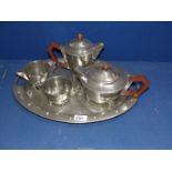 A heavy Art Deco four piece Pewter tea set to include; teapot, hot water jug,