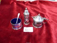 A three piece silver cruet set complete with blue liners,