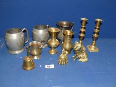 A quantity of brass and metals to include; candlesticks, bells, dogs, etc and two pewter tankards.