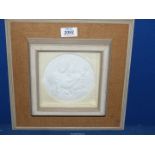 A Relief in plaster or bisque porcelain depicting 'Madonna Della Seggiola' by Raphael showing