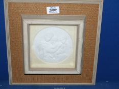 A Relief in plaster or bisque porcelain depicting 'Madonna Della Seggiola' by Raphael showing