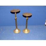 A pair of telescopic brass stands.