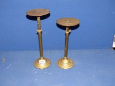 A pair of telescopic brass stands.