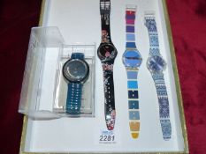 Four Swatch watches, various designs.