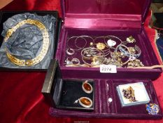 A red velvet covered jewellery box and contents including; costume rings, bangles, brooches,
