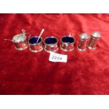 A Silver cruet set with blue glass liners and two spoons, hallmarks for Birmingham 1931 and 1932,