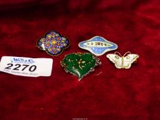 Four small enamelled brooches to include; blue and floral silver backed,