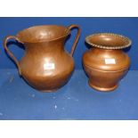 A baluster shaped copper Urn, hand beaten with two handles 10" tall,