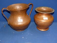 A baluster shaped copper Urn, hand beaten with two handles 10" tall,