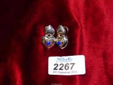 A pair of silver and 18ct gold stud and hinged back earrings in the form of two cushioned hearts