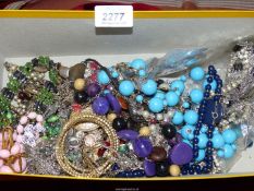 A box of assorted costume jewellery including; beads, chains, bracelets, etc.
