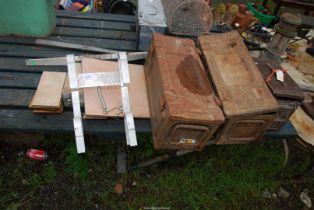 An aluminum ladder stand-off, and three military shell case boxes.