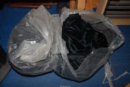 Two bags of black velvet curtains.