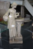 A concrete figure of a women holding two urns pouring into a font - 23½" high.