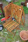 Four fold up wrought iron chairs.