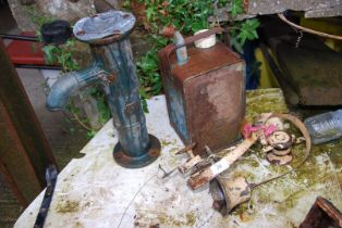 Two servant bells, an old fuel can, and a cast water pump head.