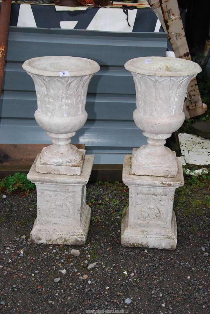 A pair of tall concrete urns standing on square plinth - 15" across x 38½" high.