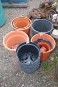 A quantity of black and terracotta planters.