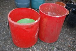 Two red water butts, plus a green Trug.
