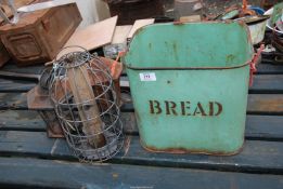 A green enamel bread bin and bird feeders.