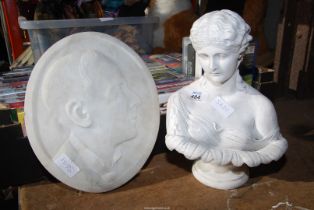 A marble wall plaque and a bust.