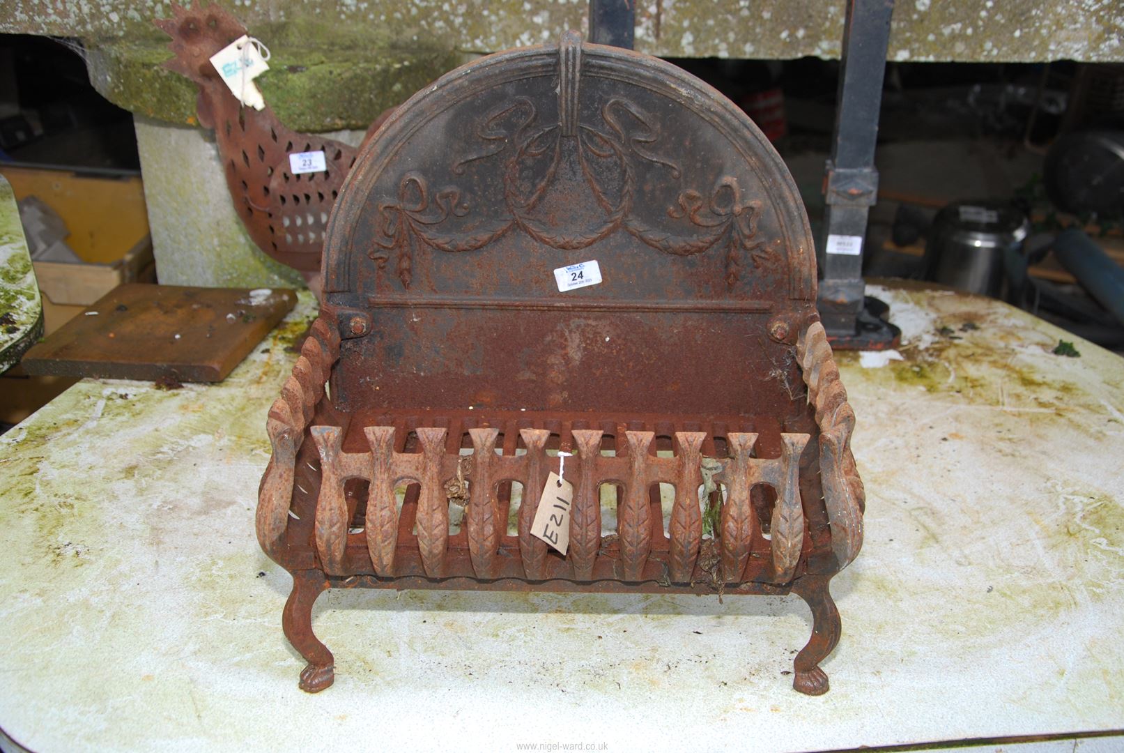 A cast iron fire grate - 18" high back, grate is 18" x 11" x 9" high.