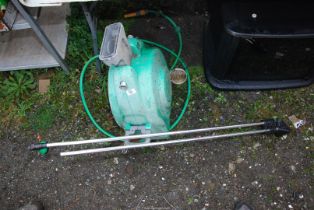 A retractable hose and a water sprinkler.