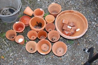 A quantity of clay pots and saucers.