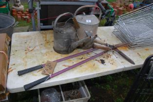 Two watering cans, and two shears.