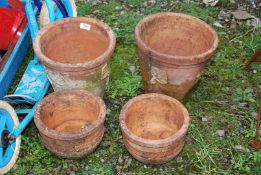 Two large and small terracotta pots.