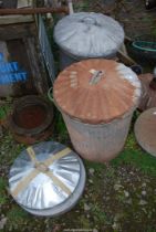 Two galvanised lidded dustbins plus two extra lids.