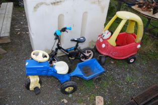 A Child's tractor and trailer, small bicycle,