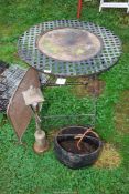 A round metal table 27½" diameter x 28½" high, a spark guard, copper lamp and cast iron swing pot.