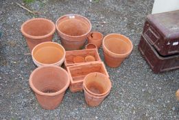 A quantity of clay pots and two oblong pots.