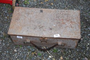 A metal toolbox containing wood brace bit, Stilsons, various old spanners, and plastering trowels.